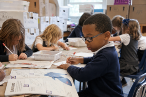 child at school learning - eye clinic opticians